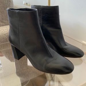 Black booties. Lightly worn. Minor scuff.